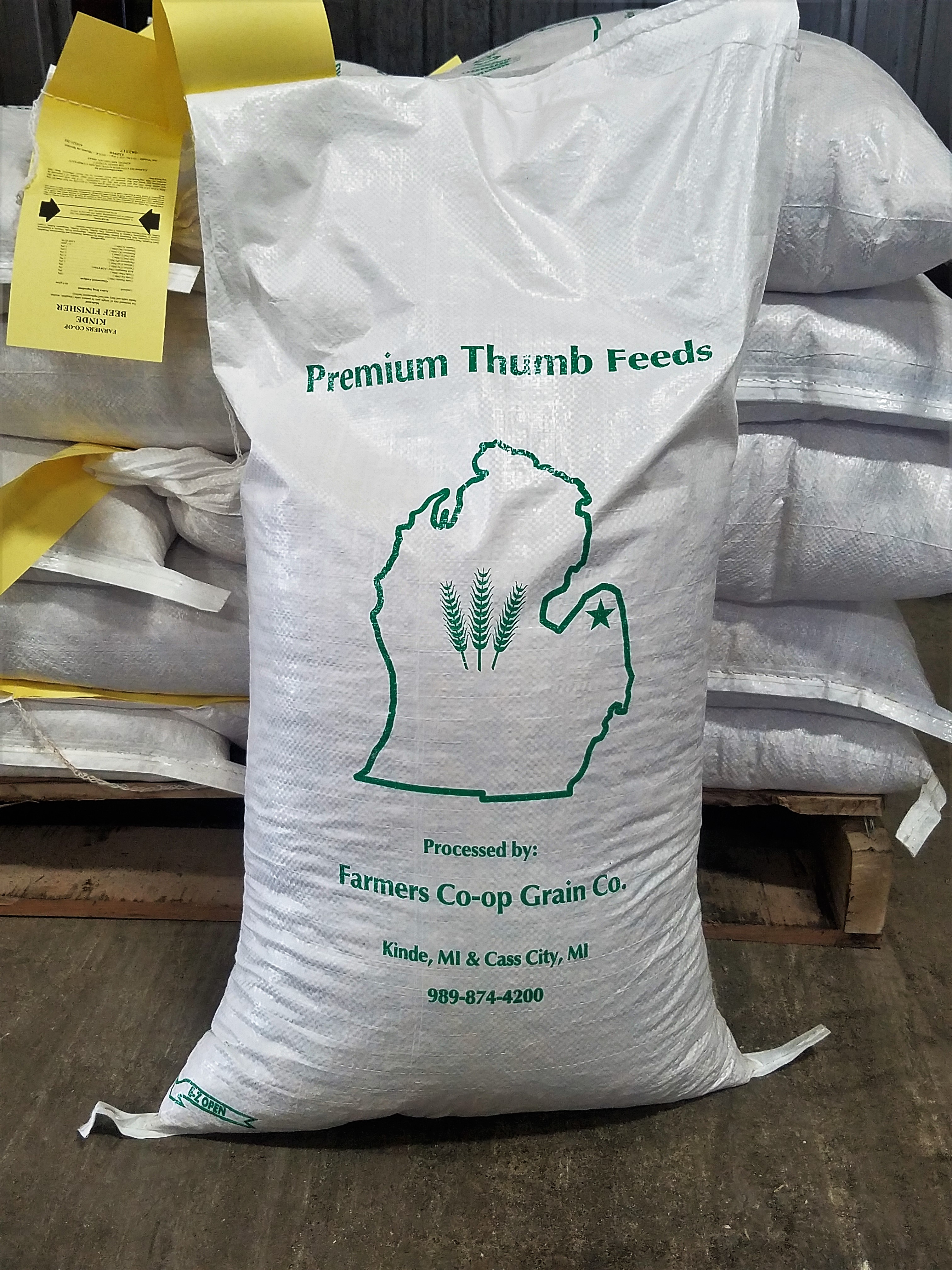 White poly feed bag with the Farmer's Cooperative contact and location information